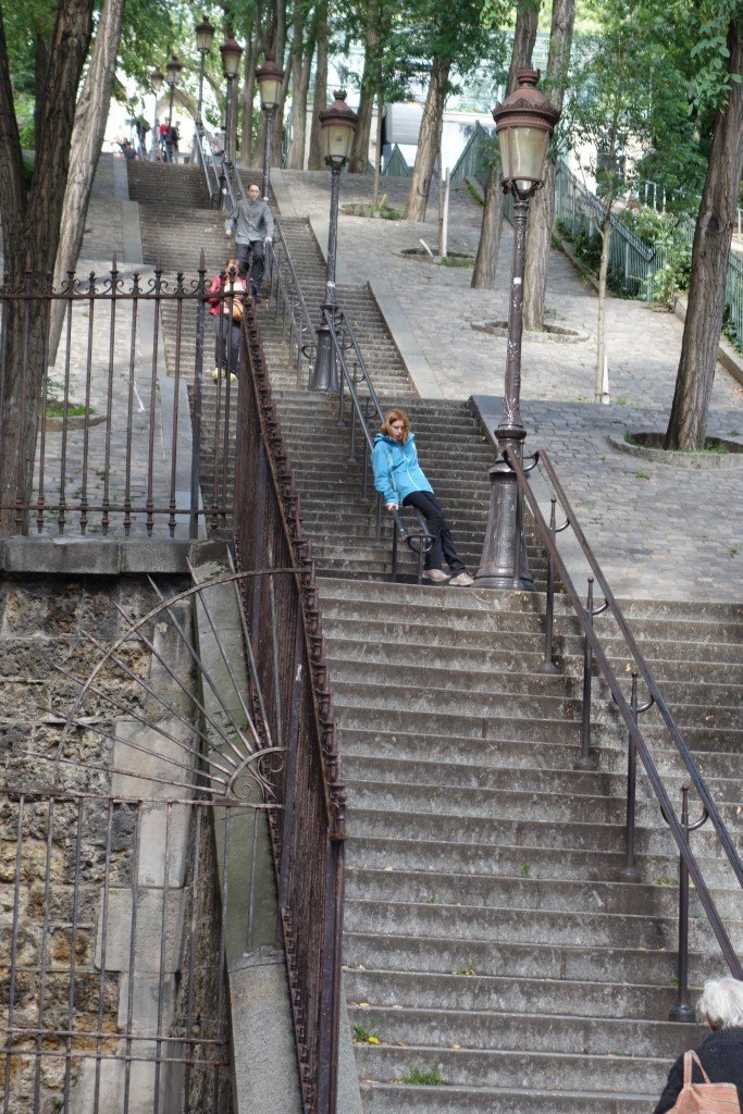 Caleb jogging and Anna sliding down Montmartre steps